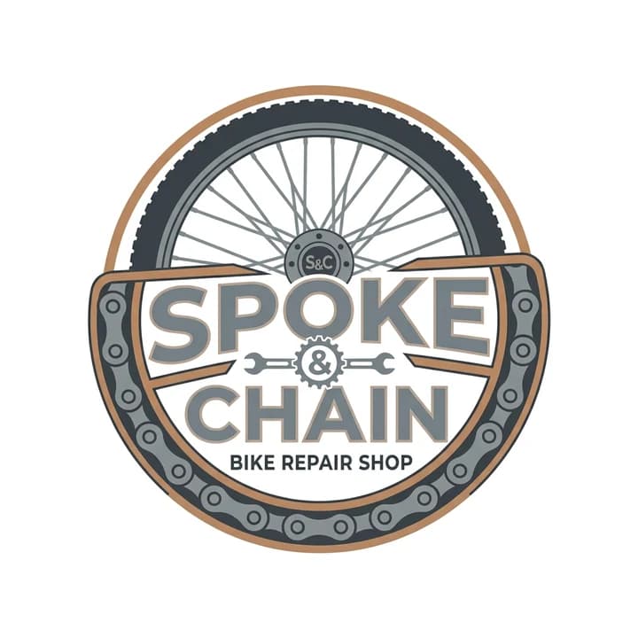 The same Spoke & Chain badge after the edit: flat tan rim, dark grey tyre and chain, grey lettering, on plain white